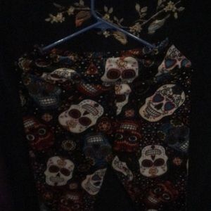 Soft black pants with candy skulls on them